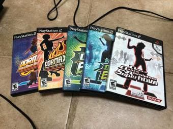 A PlayStation 2 with 2 DDR Pads and 5 DDR games, Wii Fit Plus w/ Game 2