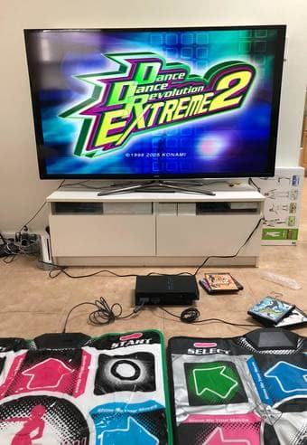 A PlayStation 2 with 2 DDR Pads and 5 DDR games, Wii Fit Plus w/ Game 3