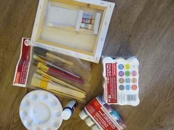 still packaged paints, unused paint brushes, canvas, and pallette 1