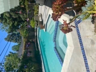 Large main bedroom with full large bathroom and view of pool 1