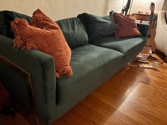 dark green velvet couch with gold hardware 1